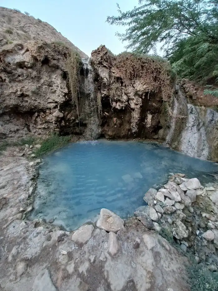 چشمه آب گرم گنو با درختان سرسبز در اطرافش 229764321025